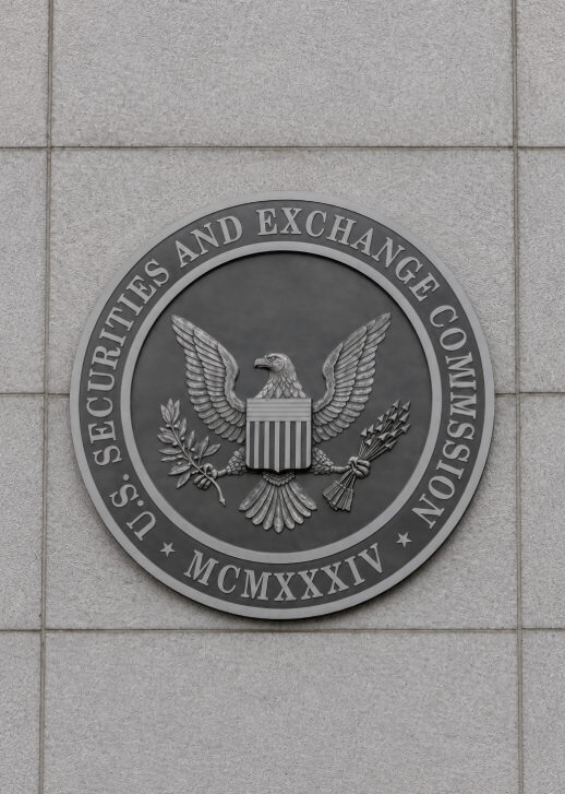 The circular seal of the U.S. Securities and Exchange Commission mounted on a light stone exterior wall, featuring an eagle and the inscription “U.S. Securities and Exchange Commission” with the Roman