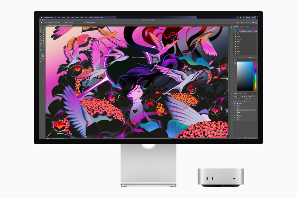 Apple desktop setup on a white background, with a silver Mac Studio beside a large monitor. The display shows a professional illustration application editing a vivid pink, purple, orange, and black ar