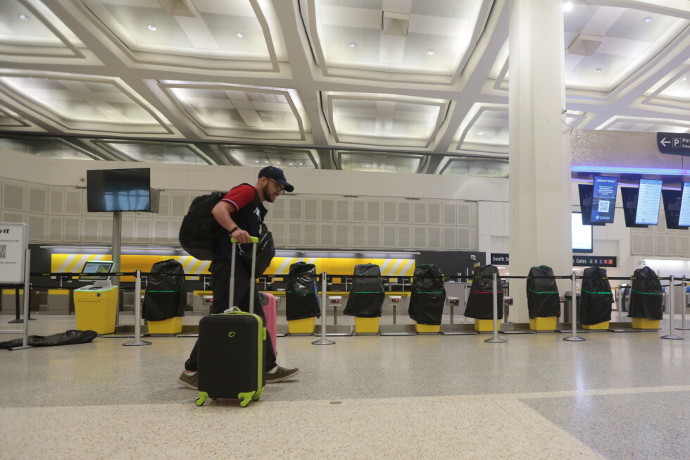 A traveler passes covered Spirit Airlines kiosks after the carrier stopped flying